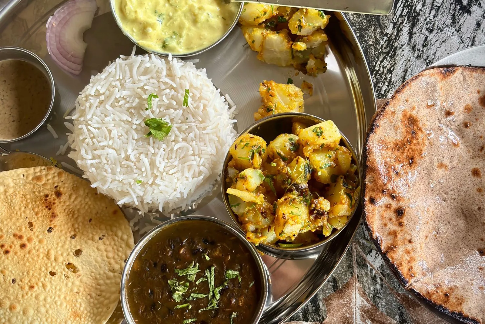 Vegetarian thali with rice, curries, roti and papad